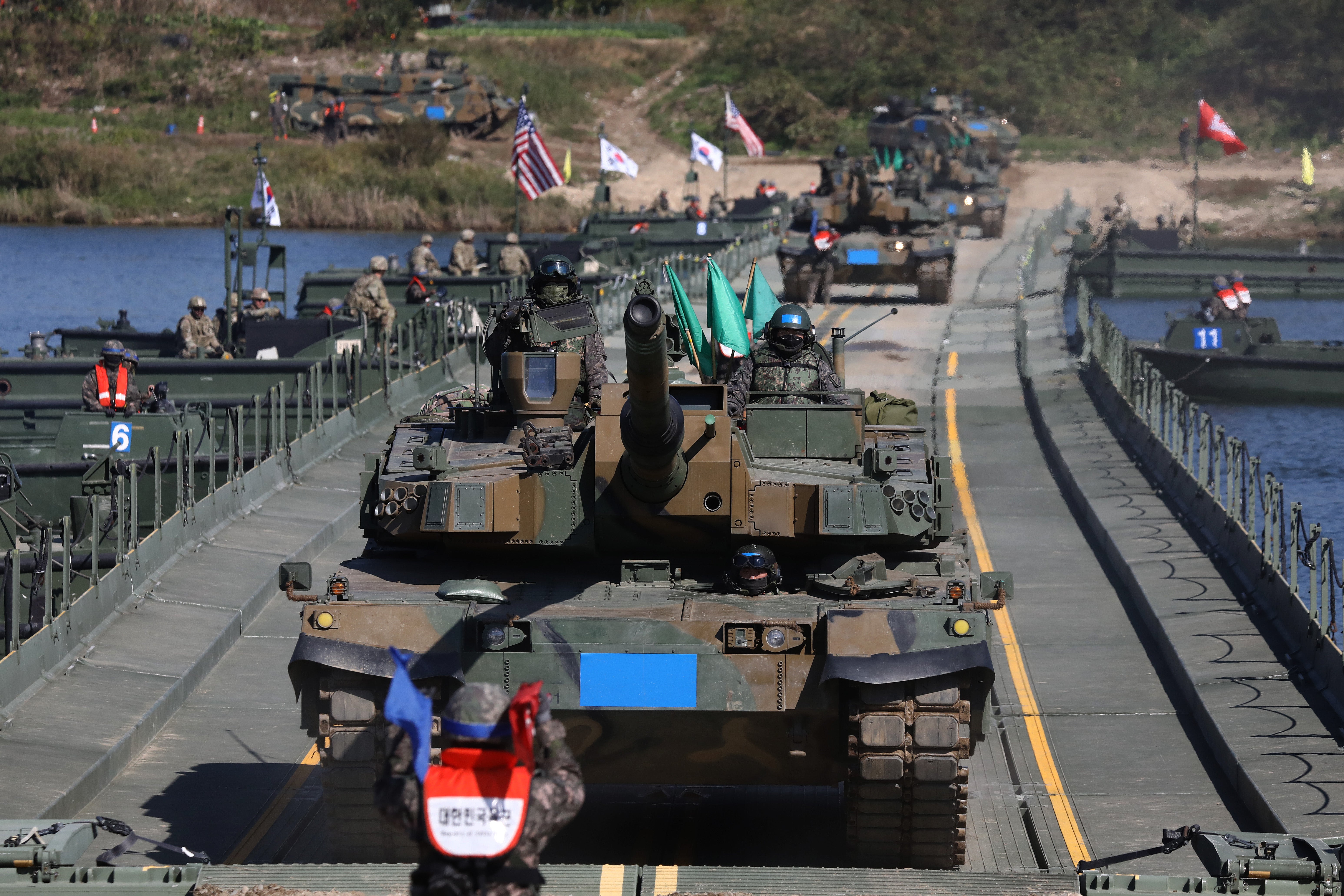 South Korean K2 tanks cross a floating bridge set up across the Namhan River