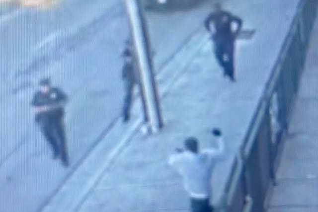 <p>Security footage shows Anthony Lowe swinging a knife above his head moments before he is shot and killed by Huntington Park police officers </p>