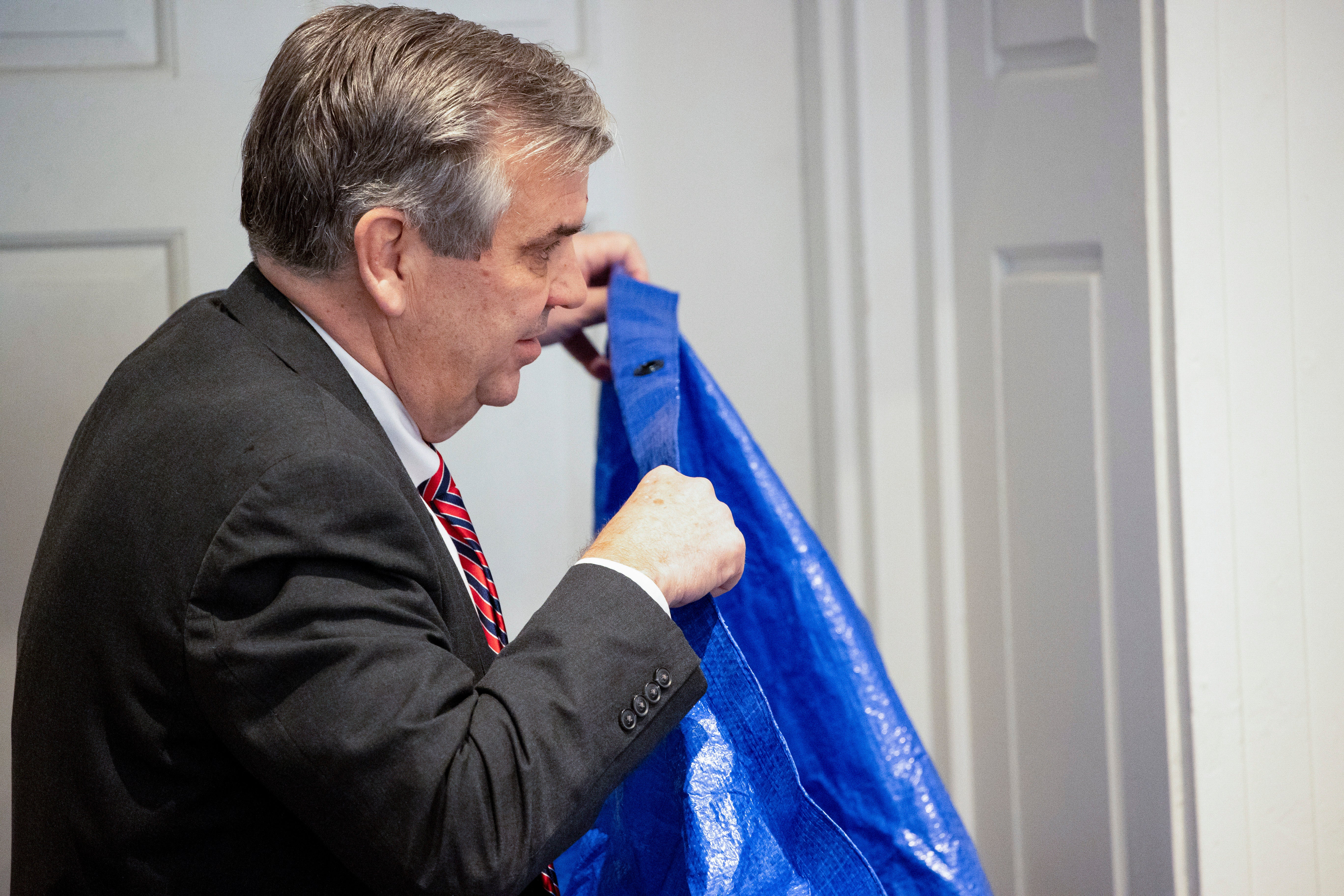 Prosecutor holds up blue tarp during trial