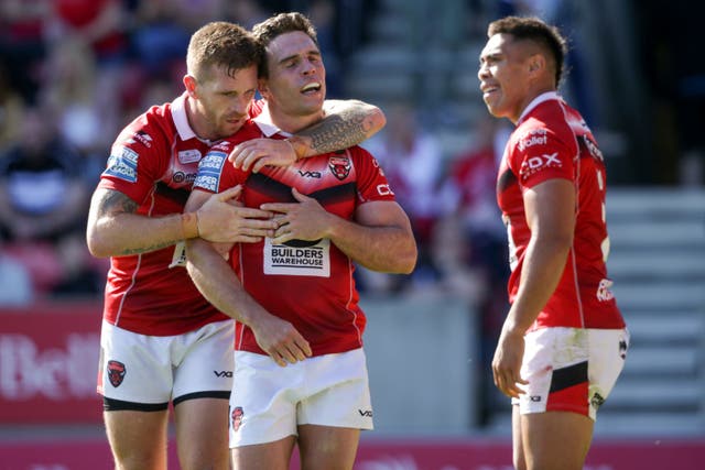 Brodie Croft, centre, has signed a new long-term deal with Salford Red Devils (Ian Hodgson/PA)