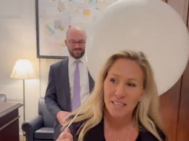 <p>Representative Marjorie Taylor Greene carrying a white balloon she intends to bring with her to the State of the Union address</p>