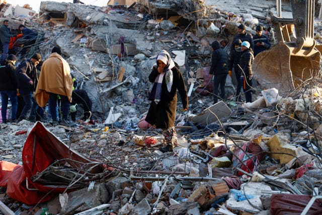 <p>A woman looks at the destruction following an earthquake in Kahramanmaras, Turkey</p>