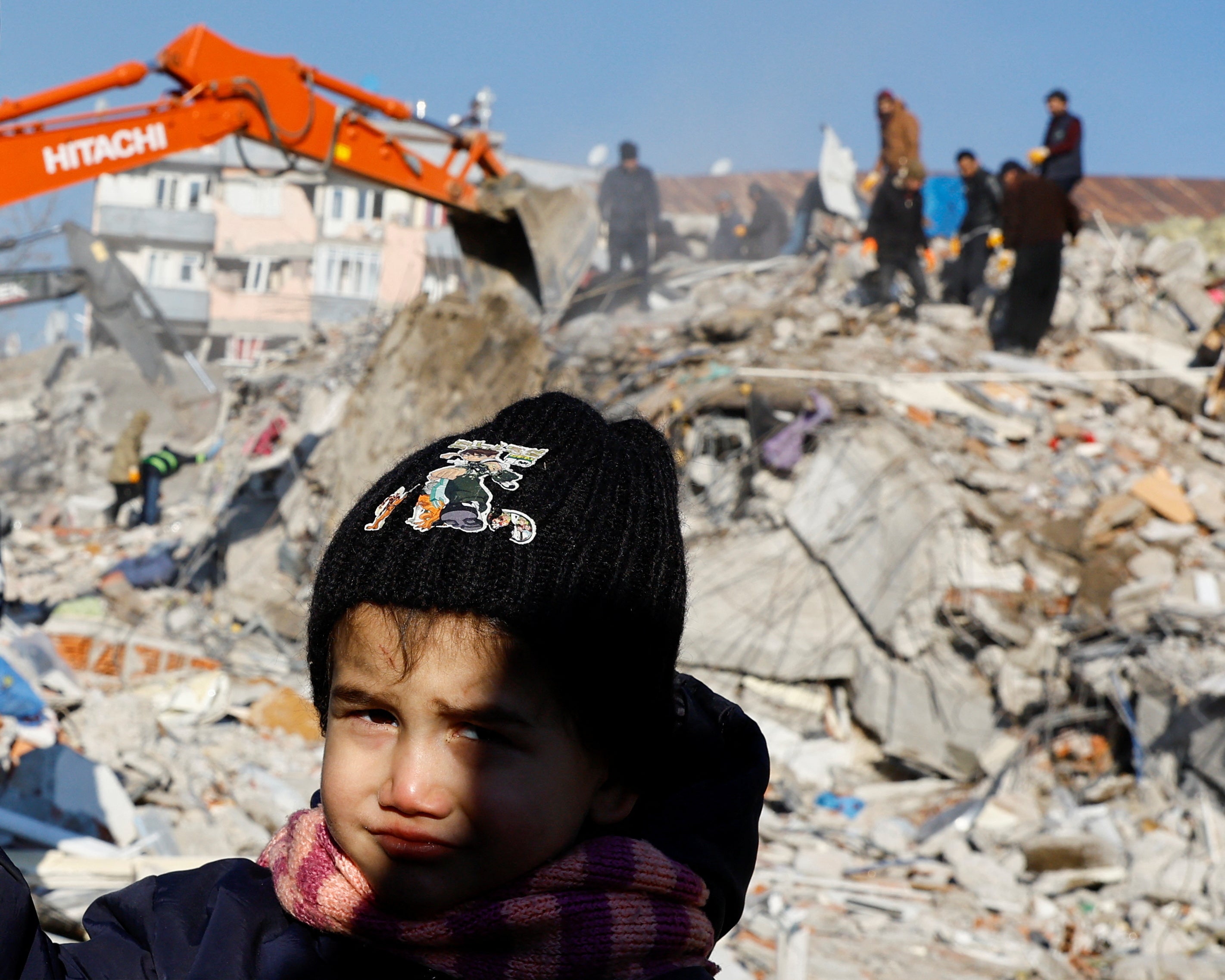 A child looks on in the aftermath of a deadly earthquake in Kahramanmaras, Turkey