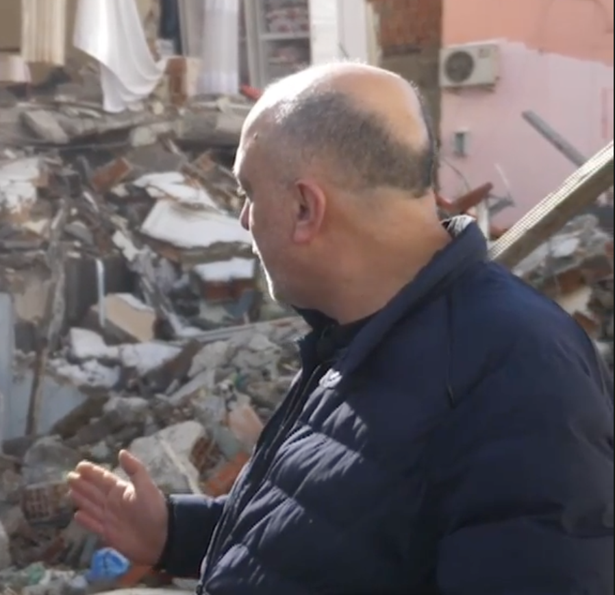 Ahmat Yilmaz stares out the skeleton of his destroyed family home in Tut