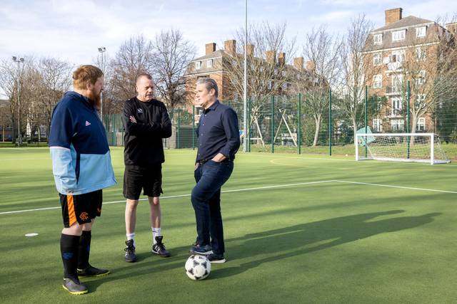 <p>Keir Starmer talks to players from his local walking football team </p>