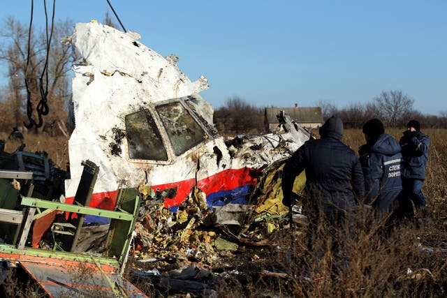 <p>Local workers transport a piece of wreckage from Malaysia Airlines flight MH17</p>