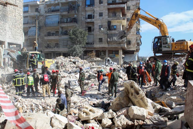 <p>Rescuers search for survivors at the site of a damaged building, in the aftermath of the earthquake in Aleppo</p>