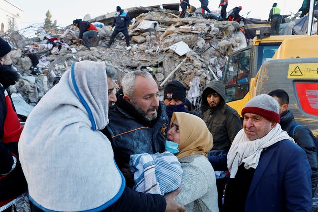 <p>A woman hugs a man as rescuers continue to search in the rubble in the aftermath of an earthquake in Kahramanmaras, Turkey, February 8, 2023. </p>