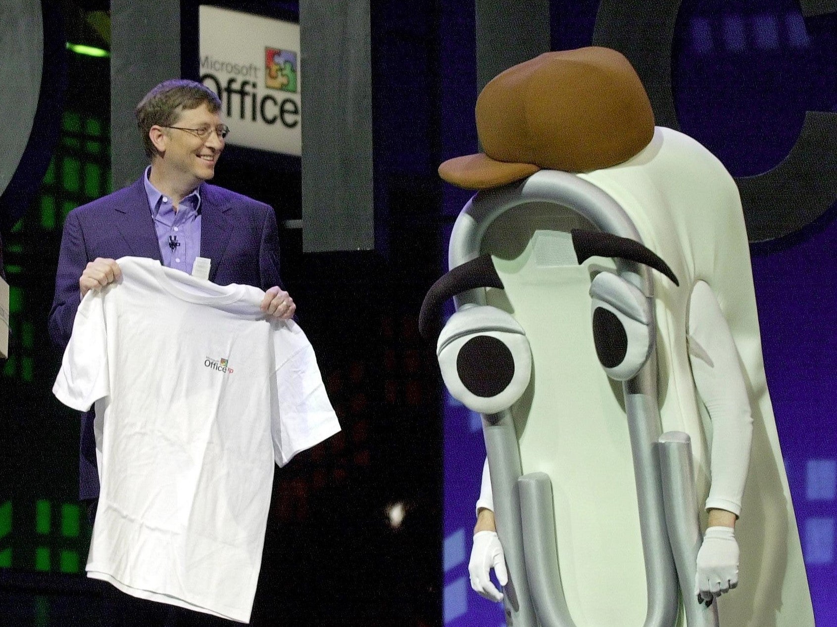 Former Microsoft CEO Bill Gates presents a T-shirt as a retirement gift to Microsoft Office Assistant ‘Clippy’ at the Office XP launch, 31 May, 2001