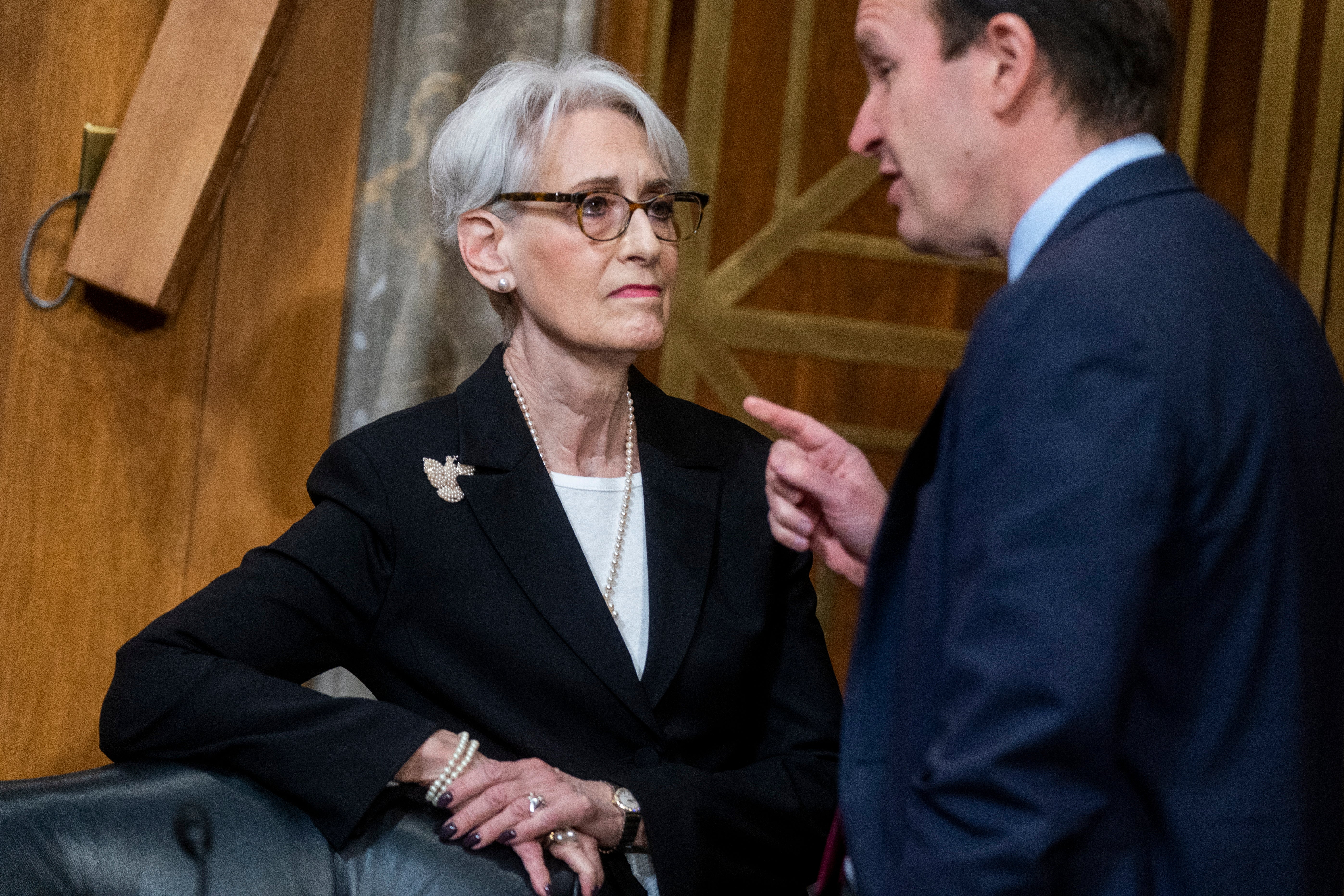 Deputy secretary of state Wendy Sherman, left, speaks with Democratic Senator Chris Murphy at a Senate Foreign Relations committee hearing on 9 February.
