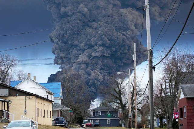 <p>A plume of smoke rising over East Palestine, Ohio following a train derailment in February </p>