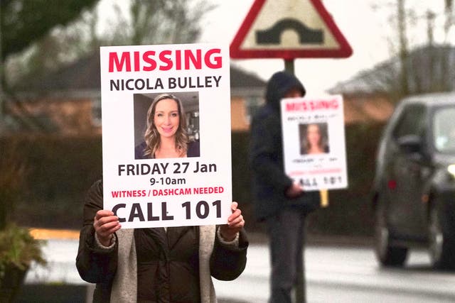 <p>Missing person posters depicting Nicola Bulley are held along a roadside in St Michael’s on Wyre, Lancashire</p>