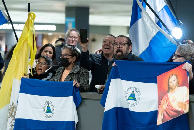 <p>Supporters of Nicaraguan political prisoners chant at Washington Dulles International Airport ahead of their arrival on Thursday 9 February 2023</p>