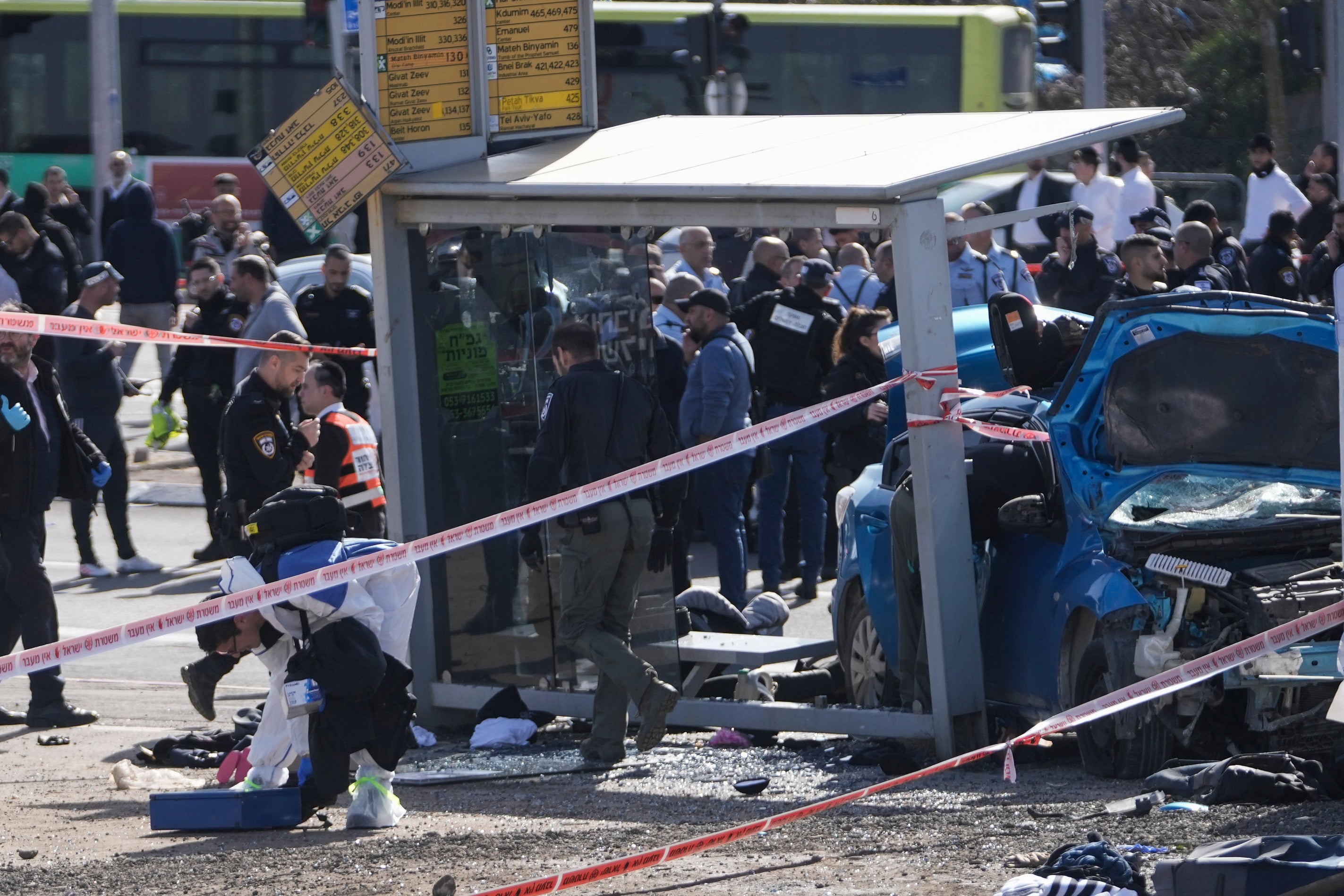 Israeli police forensic team work at the scene in Ramot, a Jewish settlement in east Jerusalem