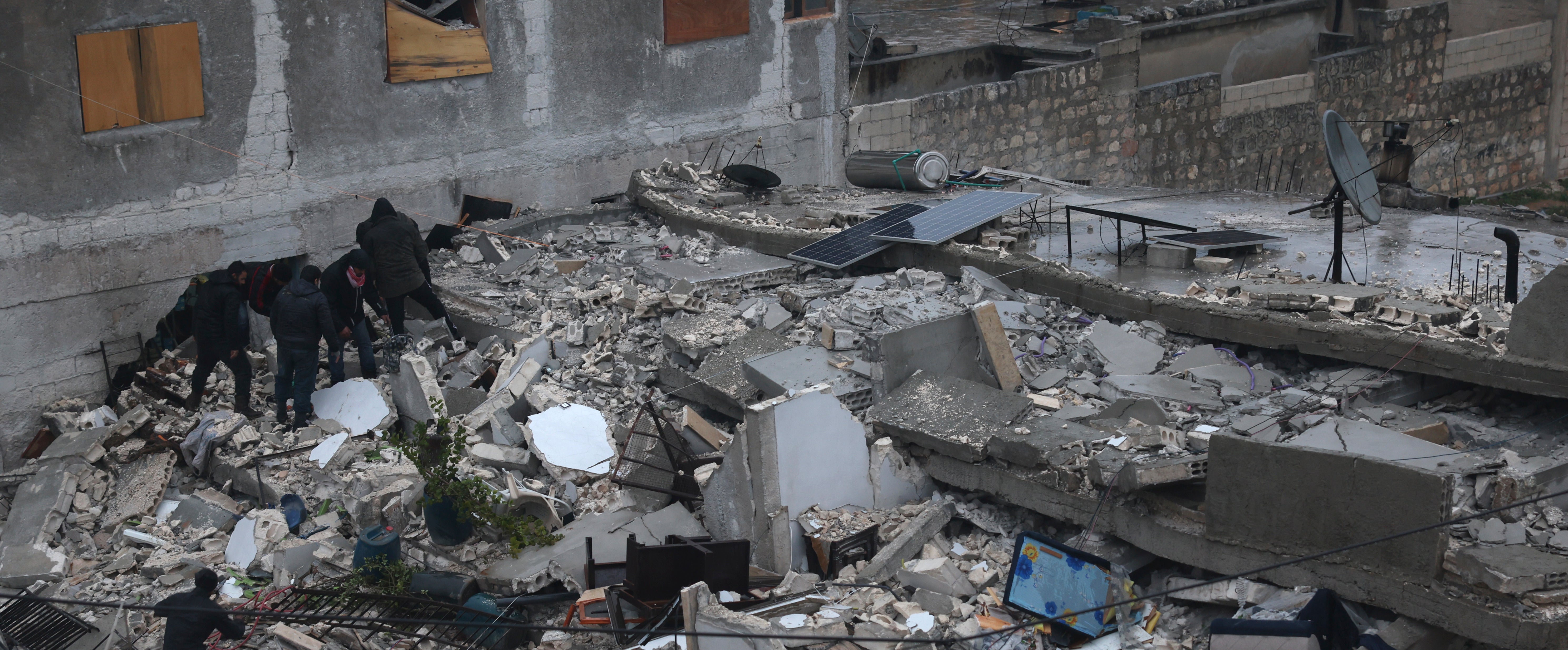 Syrian citizen have been searching through the wreckage of a collapsed building, in Azmarin town, in Idlib province north Syria