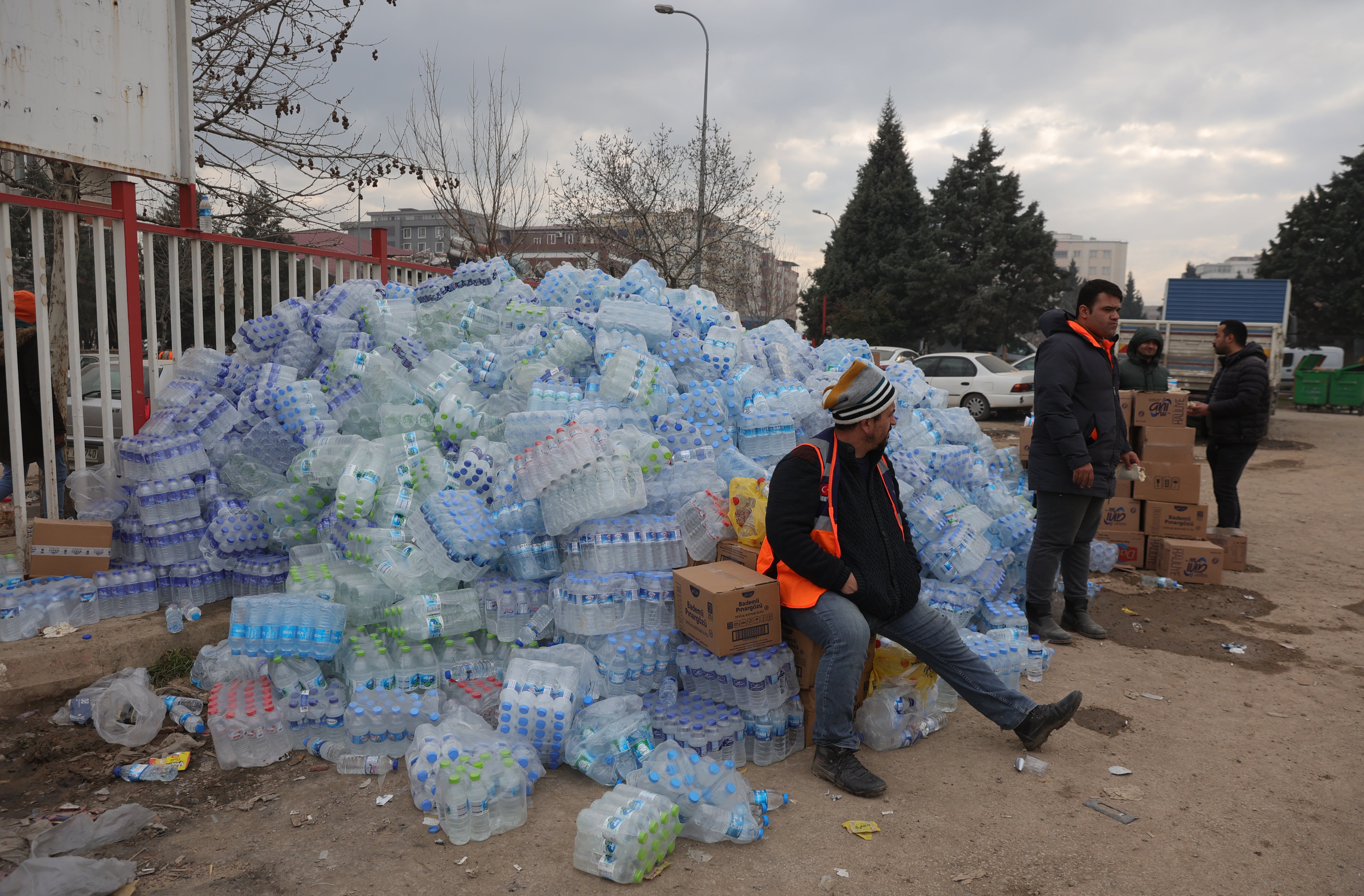 Crates of water pile up at an AFAD makeshift camp erected in a stadium in the city of Kahramanmaras, southeastern Turkey