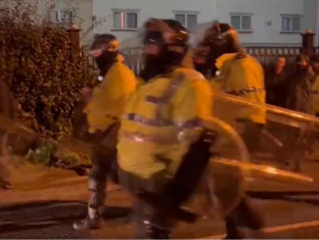 <p>Police in riot gear at the scene of the incident in Knowsley </p>