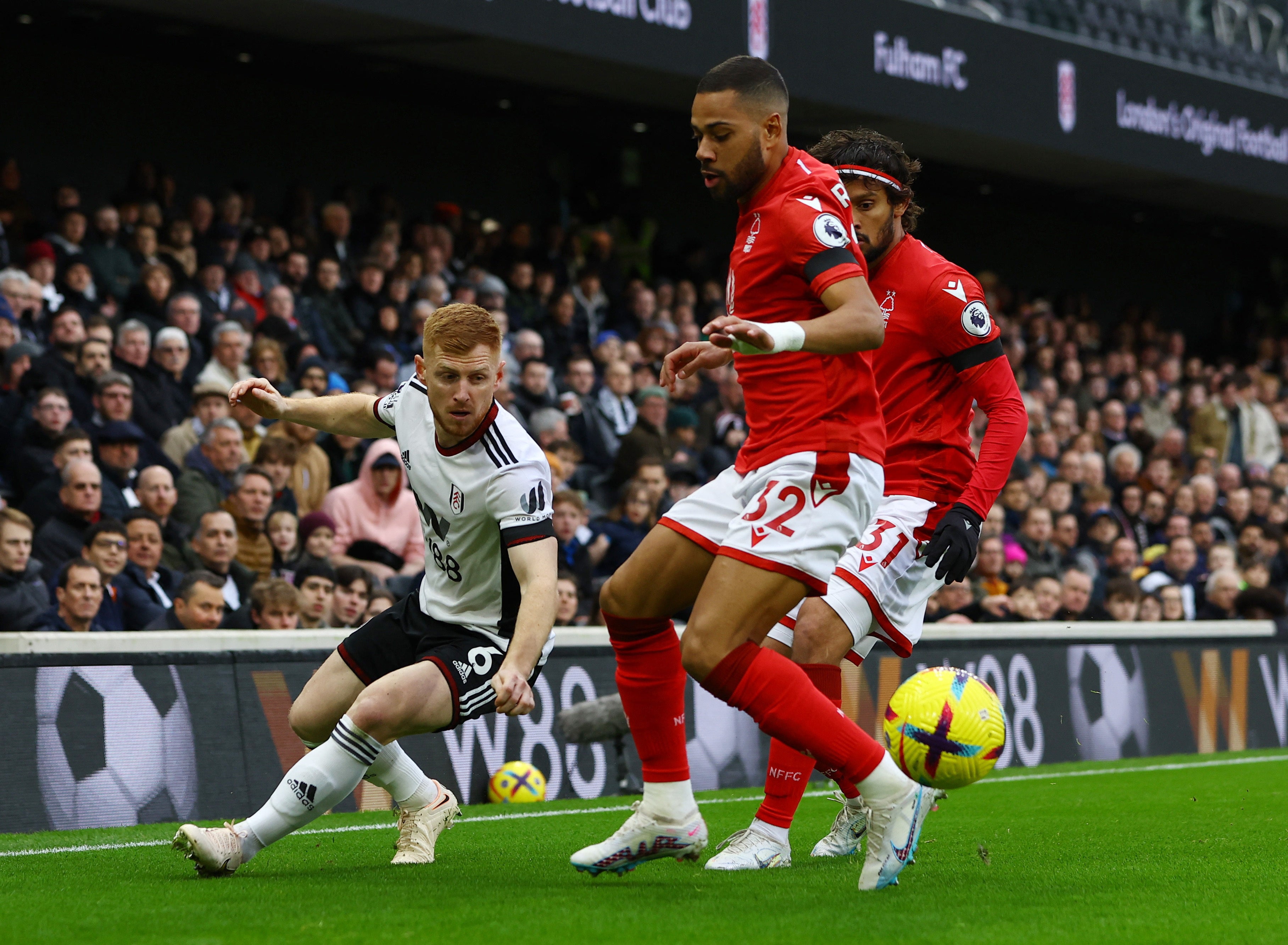 Fulham’s Harrison Reed battles two Forest players
