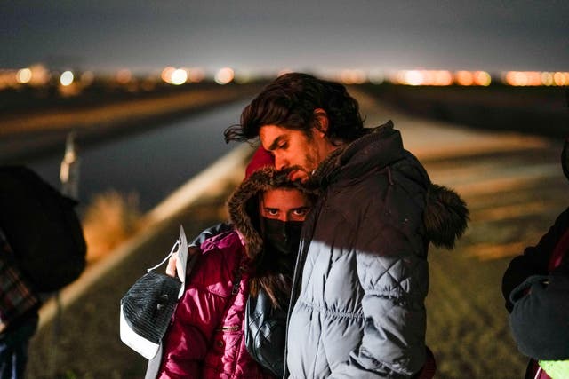 <p>A couple from Cuba wait to be processed to seek asylum after crossing the border into the United States, Friday, Jan. 6, 2023, near Yuma, Ariz. </p>