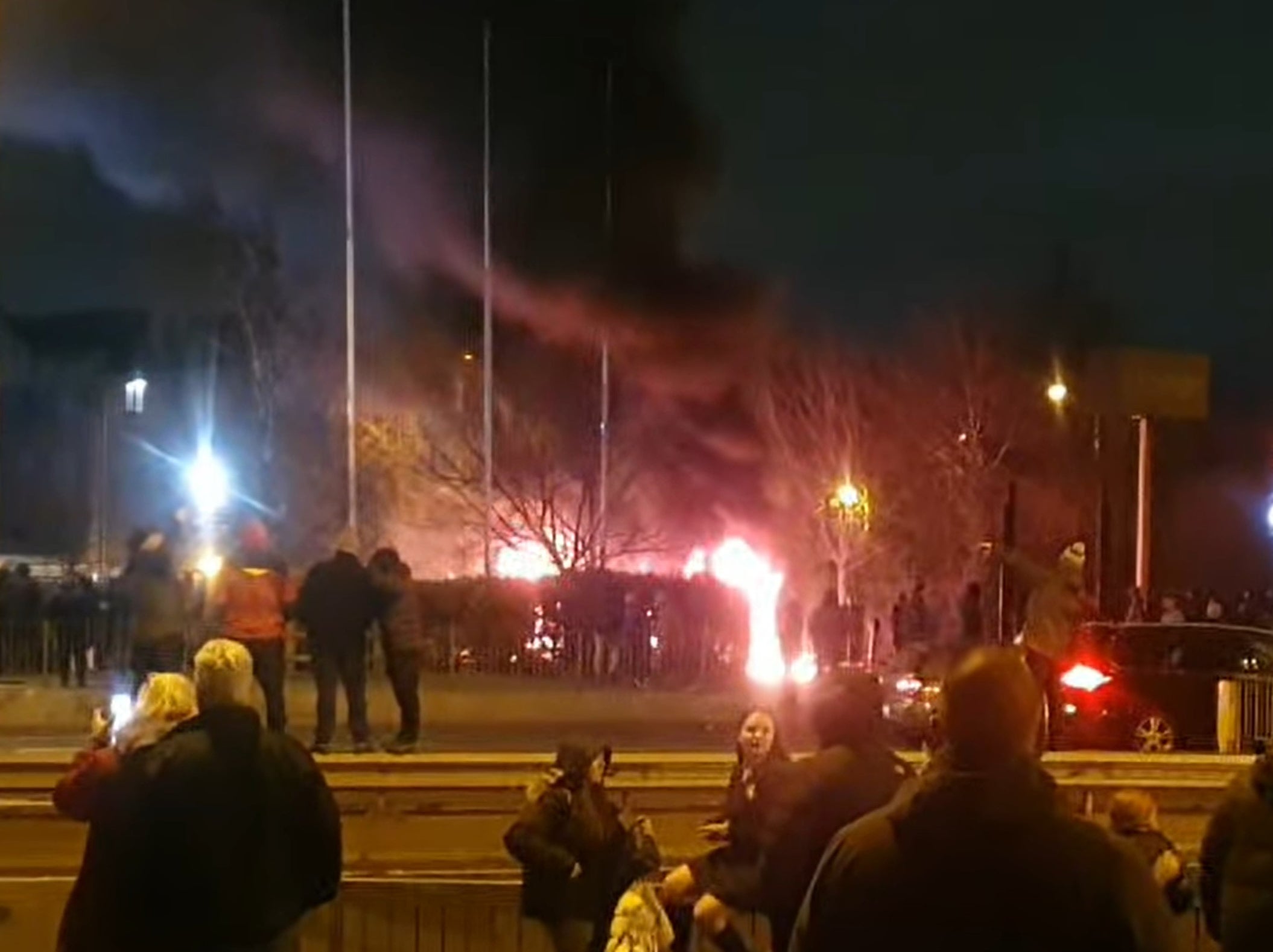 A police officer and two members of the public were hurt as missiles including lit fireworks were thrown