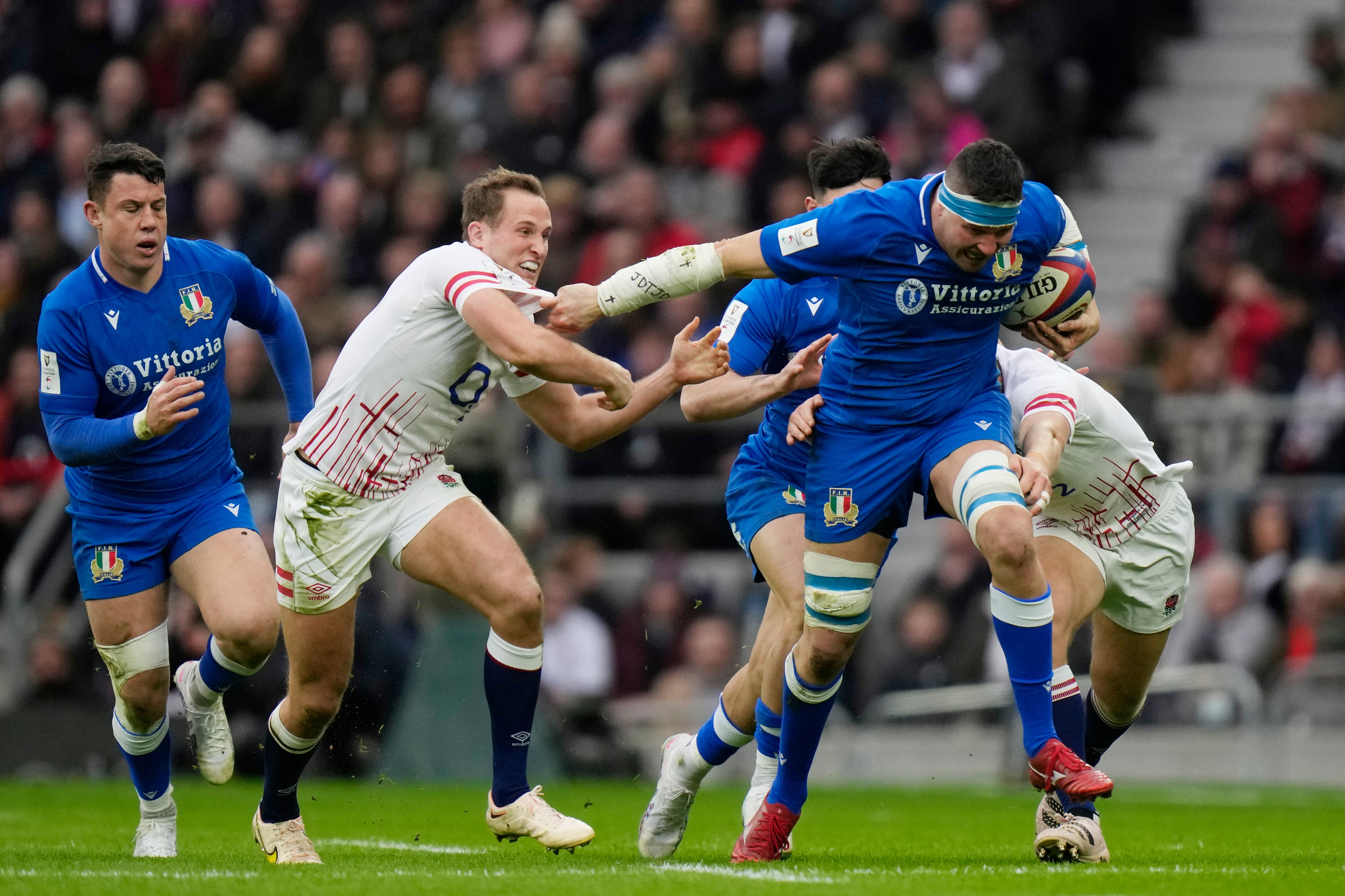 Italy’s Sebastian Negri, right, holds off England’s Max Malins