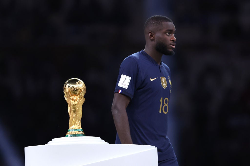 Upamecano passes the World Cup trophy after defeat to Argentina