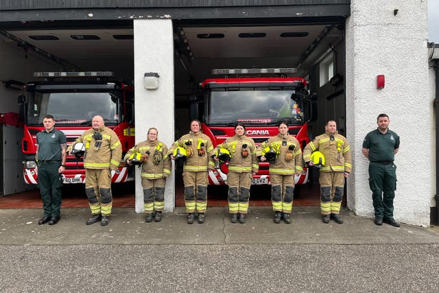 Firefighters in Campbeltown observe the minute’s silence for Barry Martin (SFRS/PA)