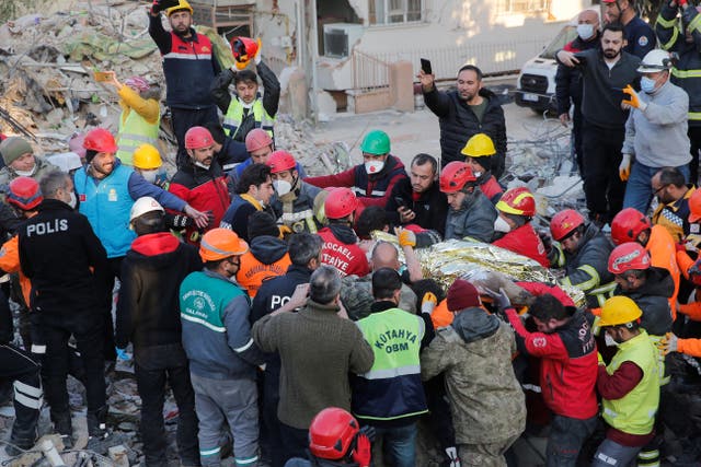 <p>Rescuer workers carry Kaan, a-13-year old Turkish teenager, to an ambulance after being rescued from the rubble after 182 hours</p>