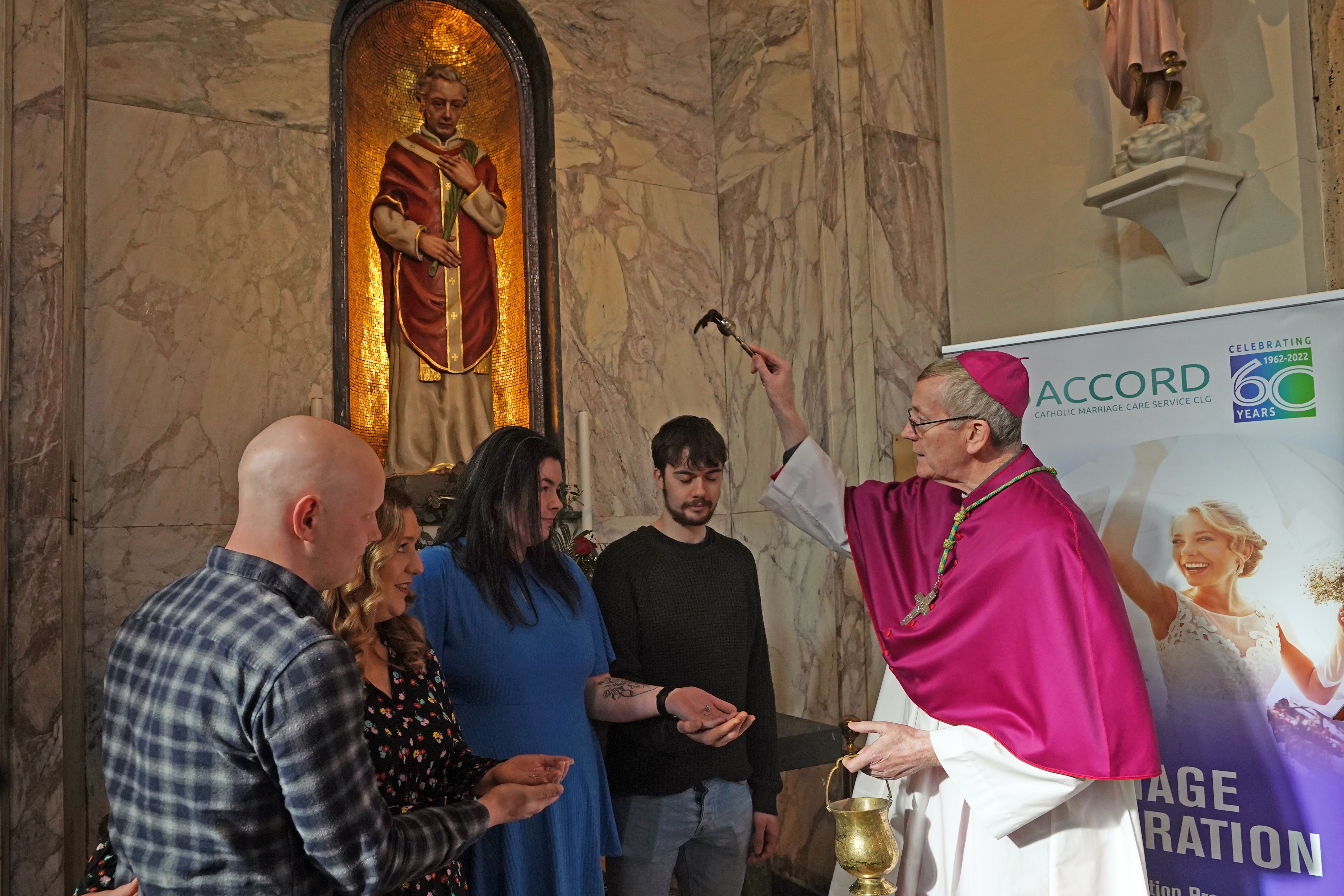 Bishop Denis Nulty blessing engaged couples (left to right) Ilona Catharine Dorrepaal and Patrick Michael Lennon, and Orla Gavin and Patrick Corcoran, at the shrine of the holy relics of St Valentine in the Carmelite Church in Dublin city (Niall Carson/PA)