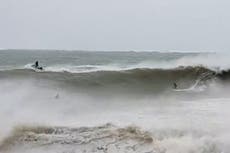 Cyclone Gabrielle: Surfers brave torrential waves in New Zealand