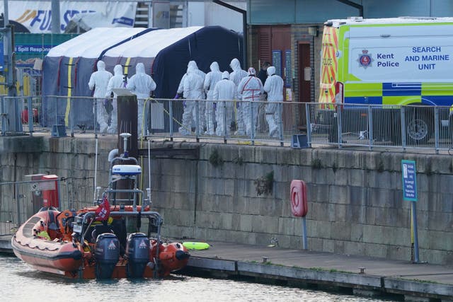 <p>Police forensic officers at the RNLI station at the Port of Dover after a large search and rescue operation following the sinking on 14 December (Gareth Fuller/PA)</p>