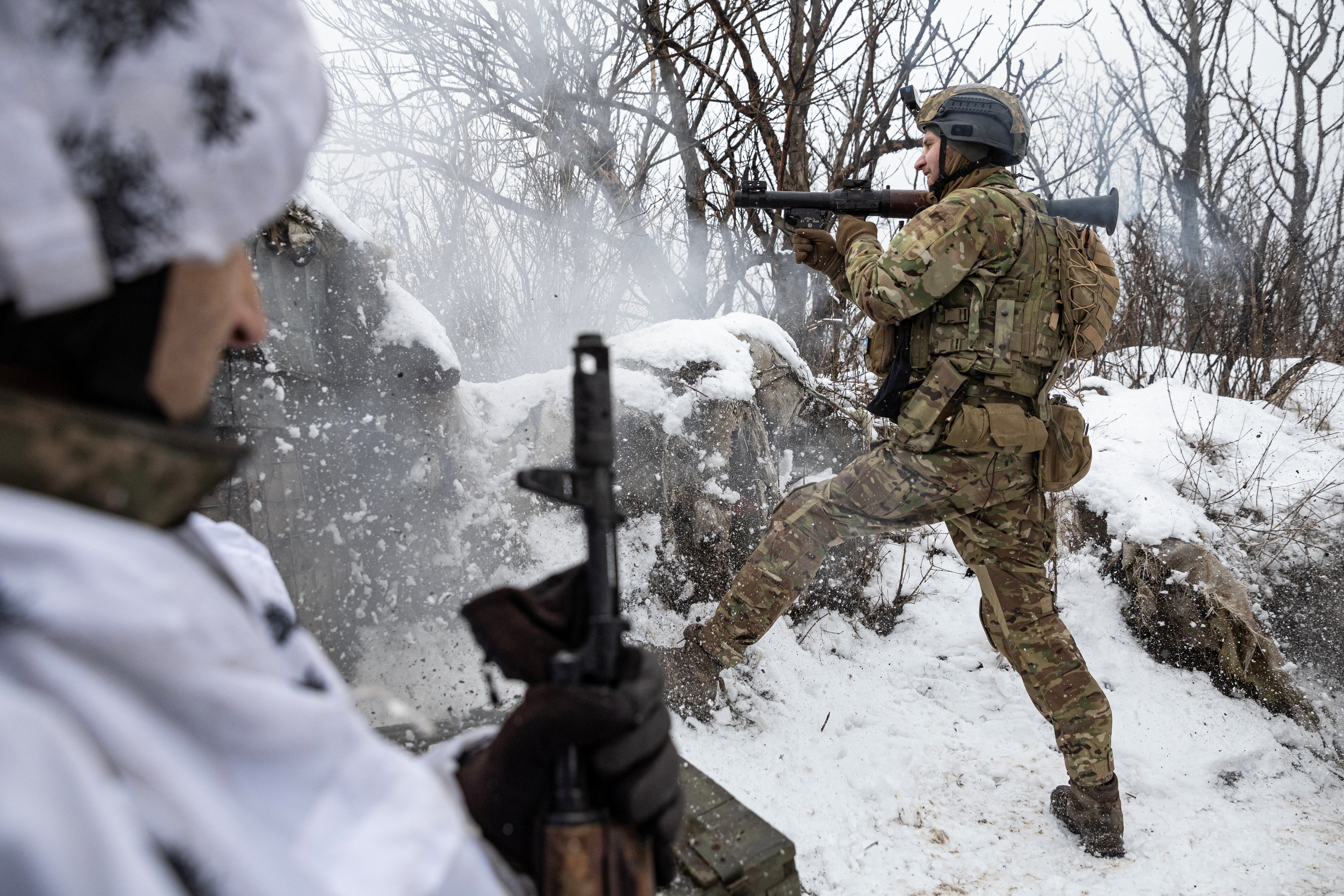 Bohdan, the deputy of commander of the unit in 79th Air Assault Brigade, fires an RPG towards Russian positions near the town of Marinka, Donetsk