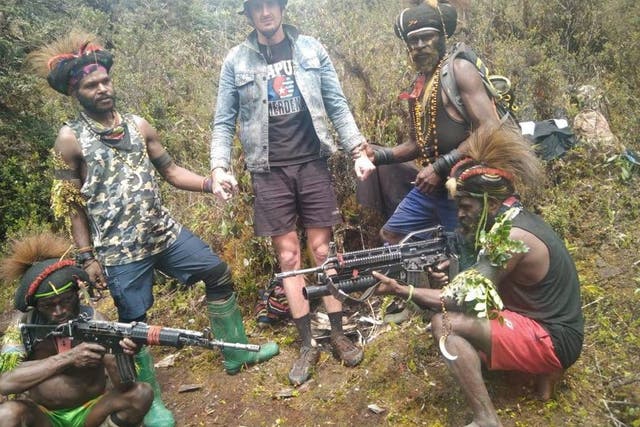 <p>A man, identified as Philip Mehrtens, the New Zealand pilot who is said to be held hostage by a pro-independence group, stands among the separatist fighters in Indonesia's Papua region</p>