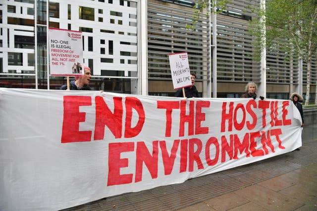 <p>Demonstrators protest against the hostile environment immigration policy outside the Home Office in Westminster, London</p>