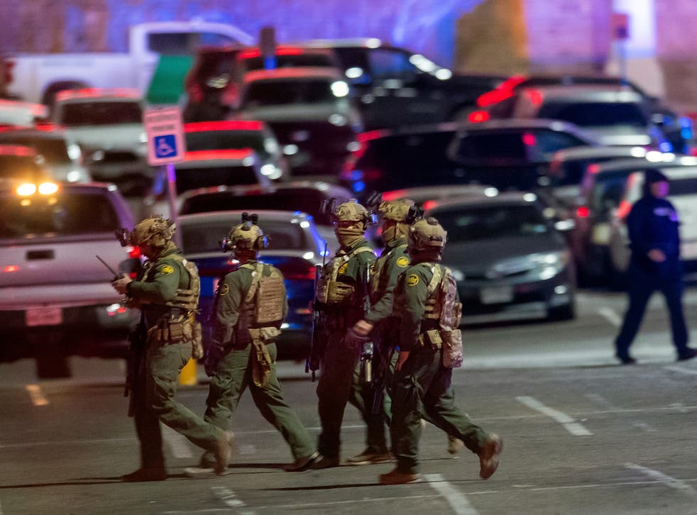 <p>Law enforcement agents walk in the parking lot of a shopping mall in El Paso, Texas</p>