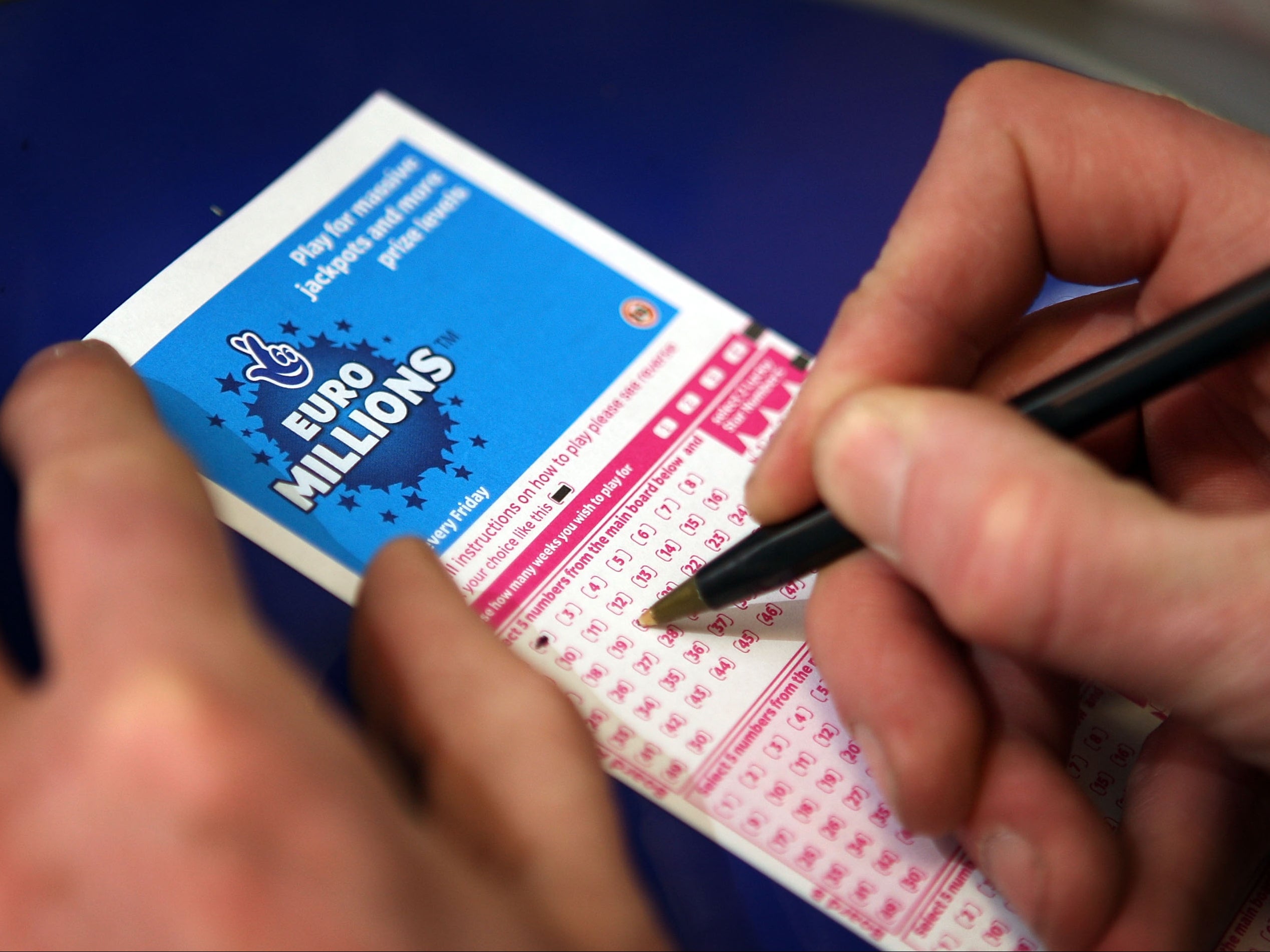 A punter fills out a National Lottery ticket in 2008