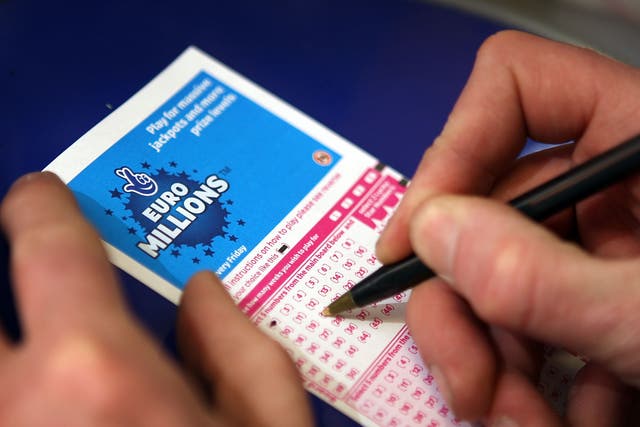 <p>A punter fills out a National Lottery ticket in 2008</p>