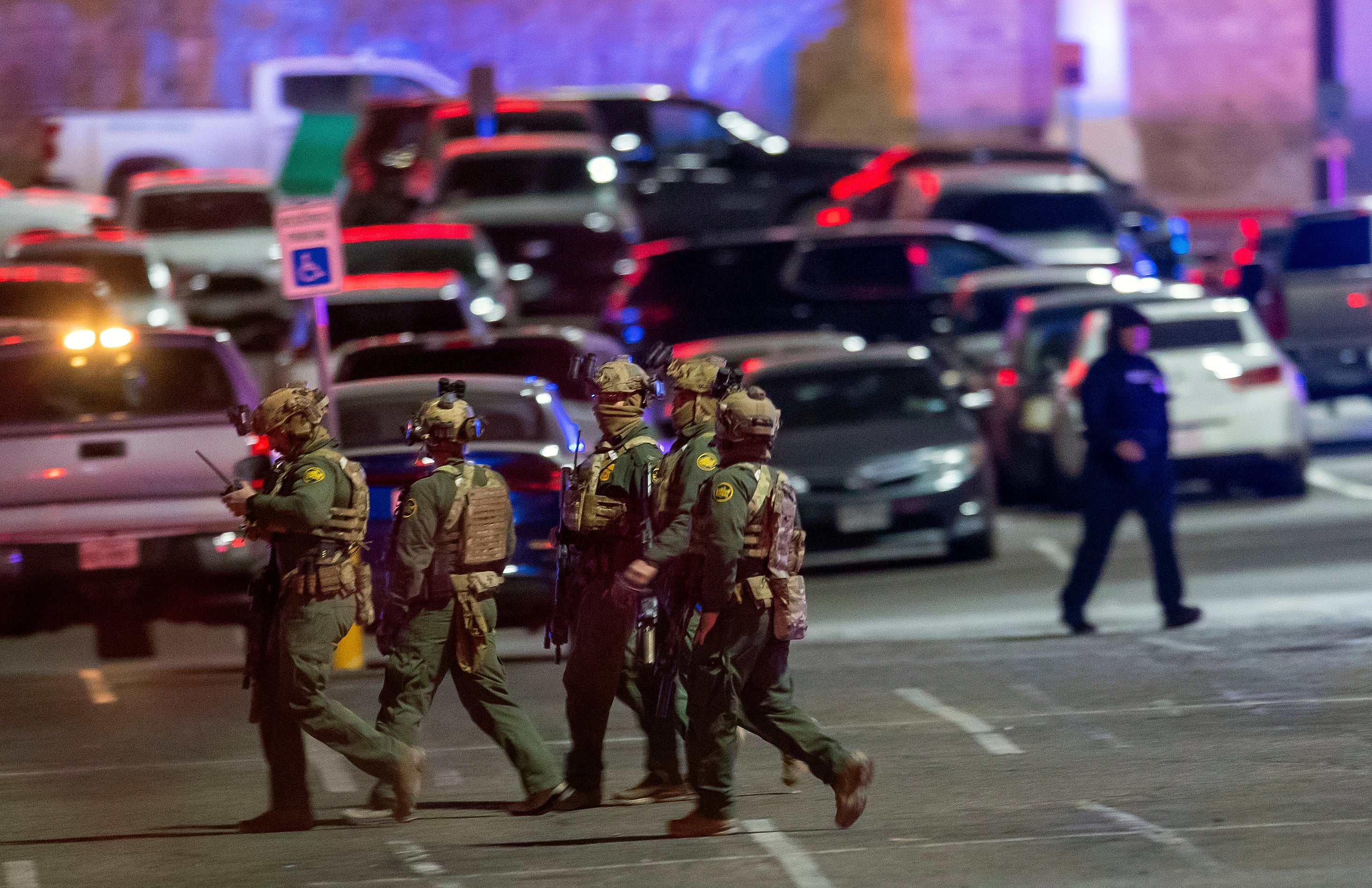 File: Law enforcement agents walk in the parking lot of a shopping mall, Wednesday, Feb. 15, 2023, in El Paso, Texas