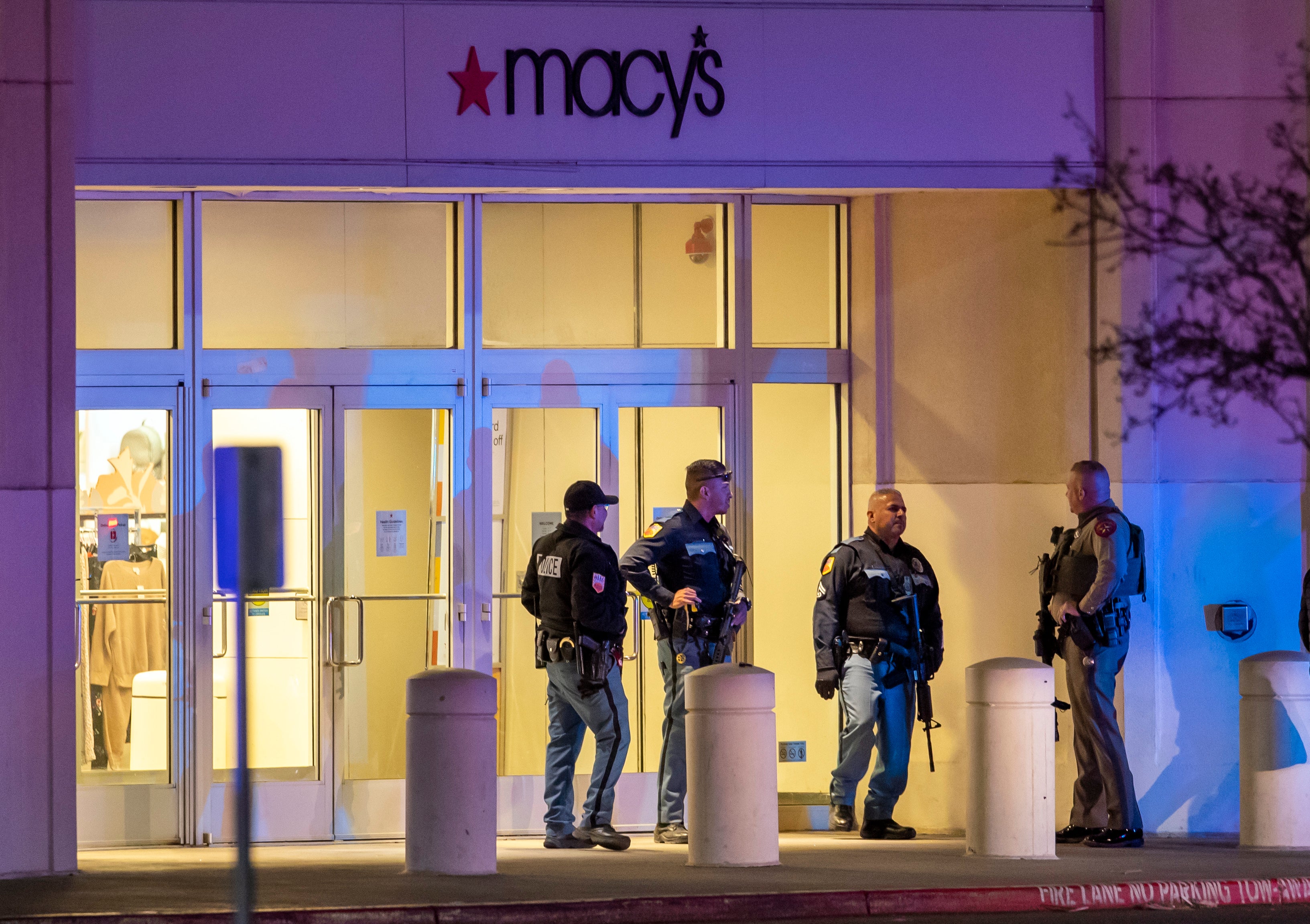 Police officers stand guard at an entrance of a shopping mall, Wednesday, Feb. 15, 2023, in El Paso, Texas