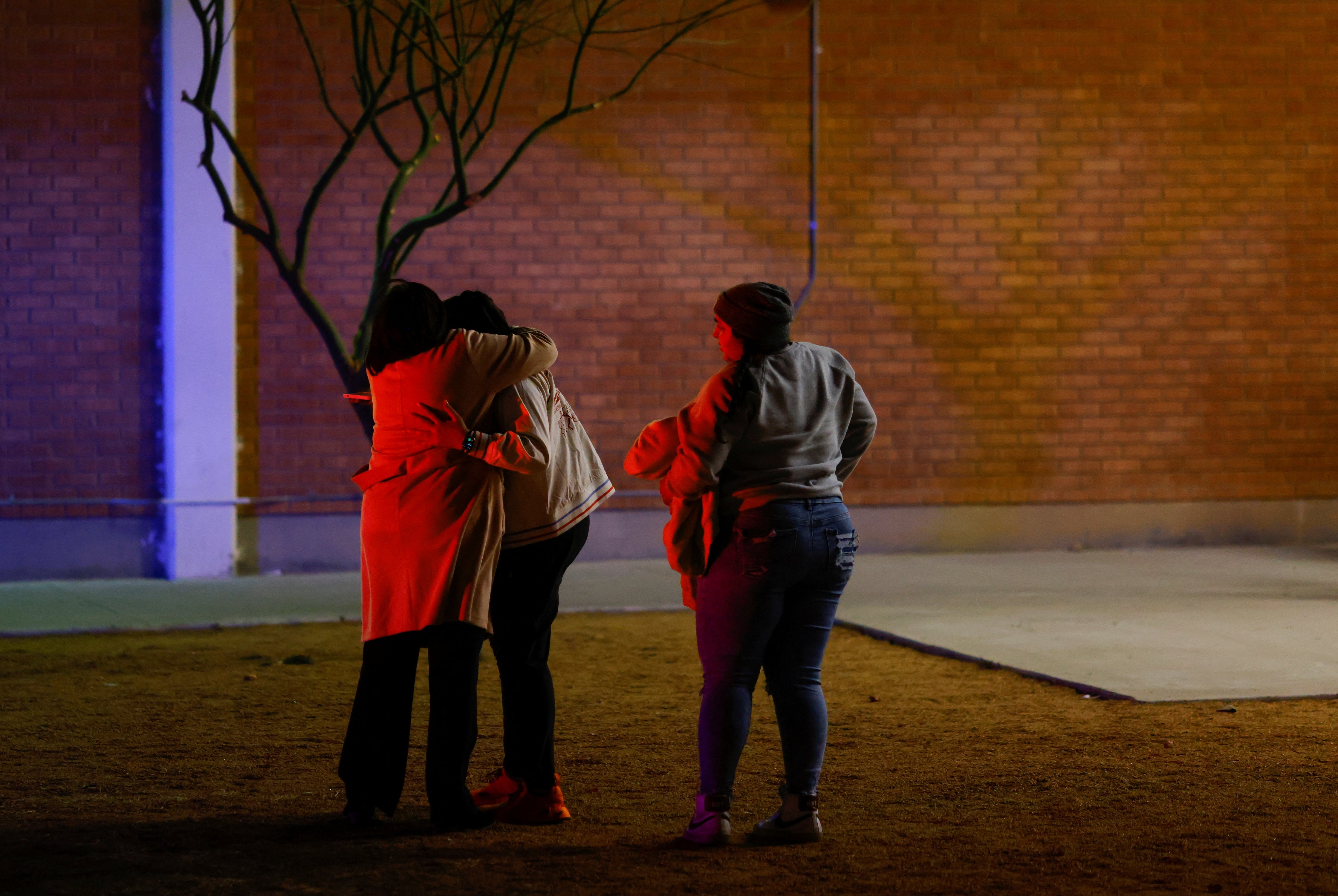 People hug each other near the Cielo Vista Mall after a shooting, in El Paso, Texas, U.S February 15, 2023