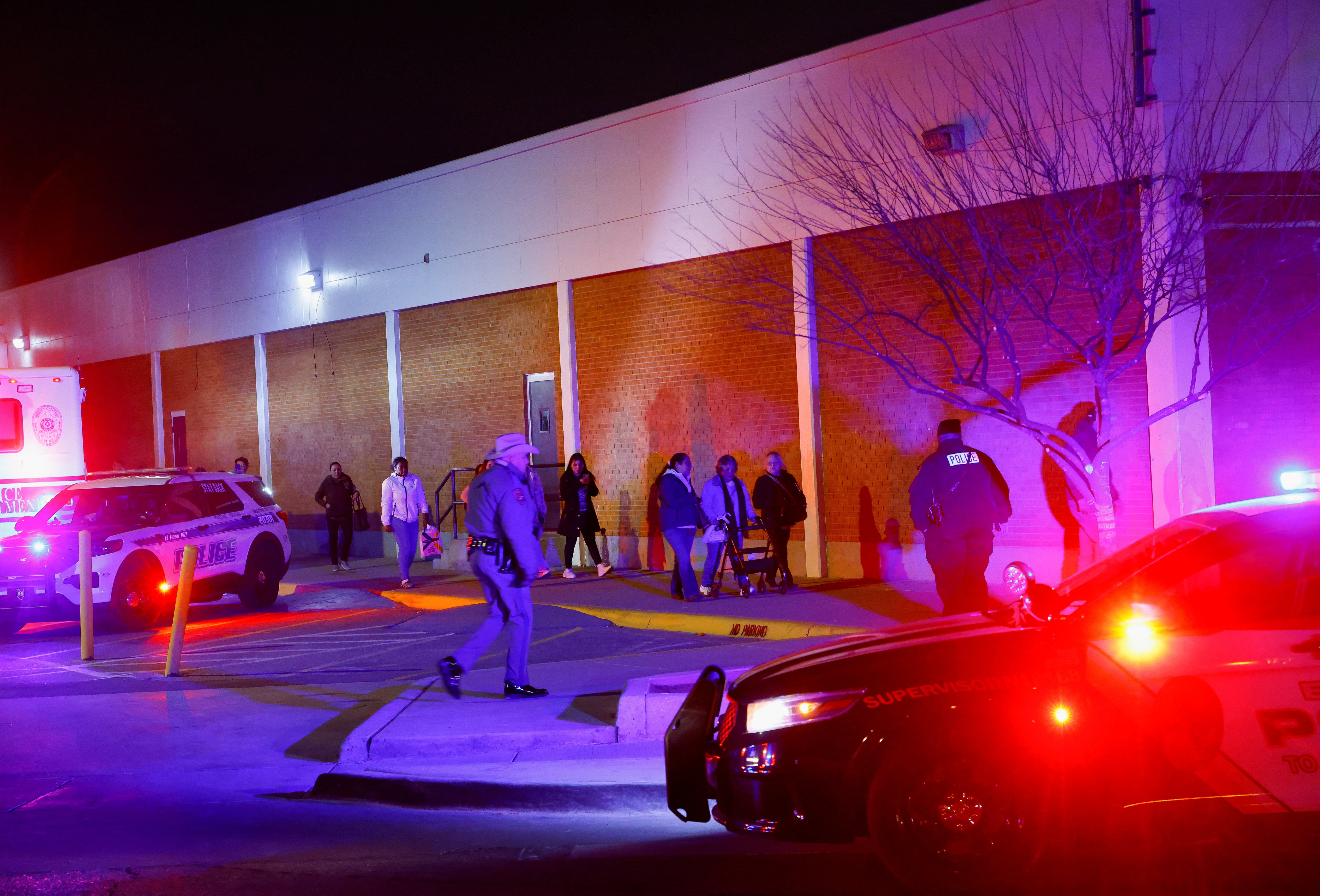 People walk near the Cielo Vista Mall after being evacuated by police following a shooting, in El Paso, Texas, U.S February 15, 2023