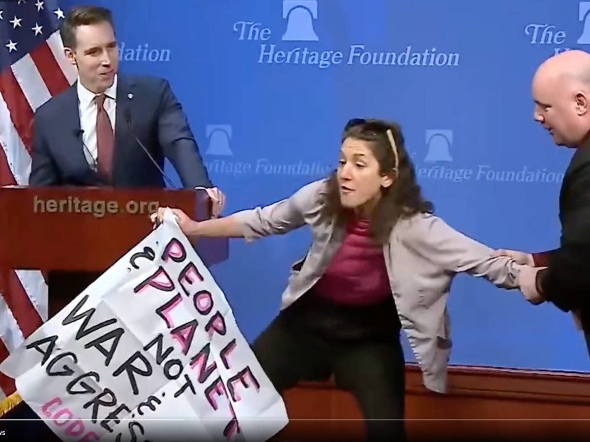 Climate protester interrupts Josh Hawley speech before being dragged off stage