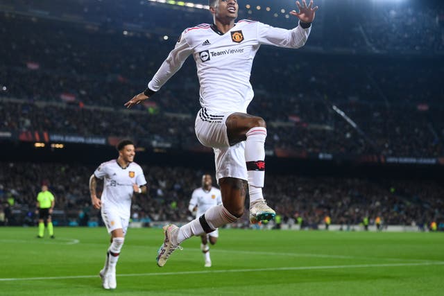<p>Marcus Rashford jumps for joy after a Barcelona own goal </p>