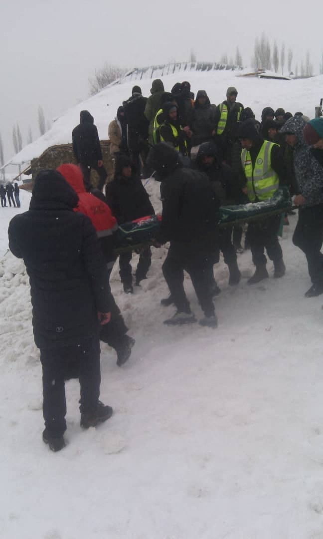 People take part in a rescue operation following an avalanche slide in Gorno-Badakhshan region