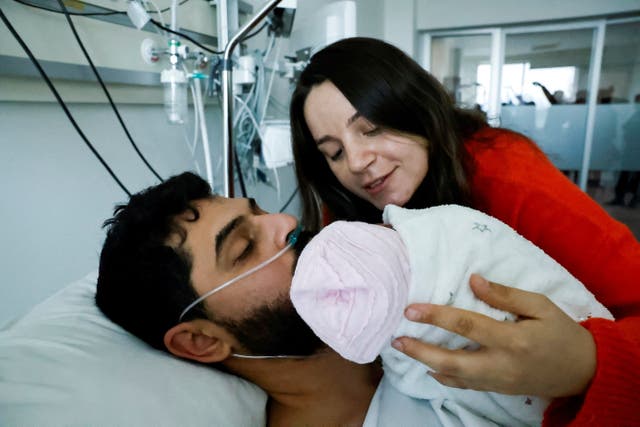 <p>Mustafa Avci, 33, who was stuck under rubble for 261 hours, meets his daughter Almile for the first time and reunites with his wife Bilge, following the deadly earthquake, at a hospital in Mersin, Turkey</p>
