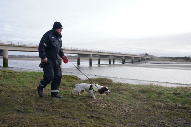Police search teams on the banks of the River Wyre in Hambleton, Lancashire (Peter Byrne/PA)