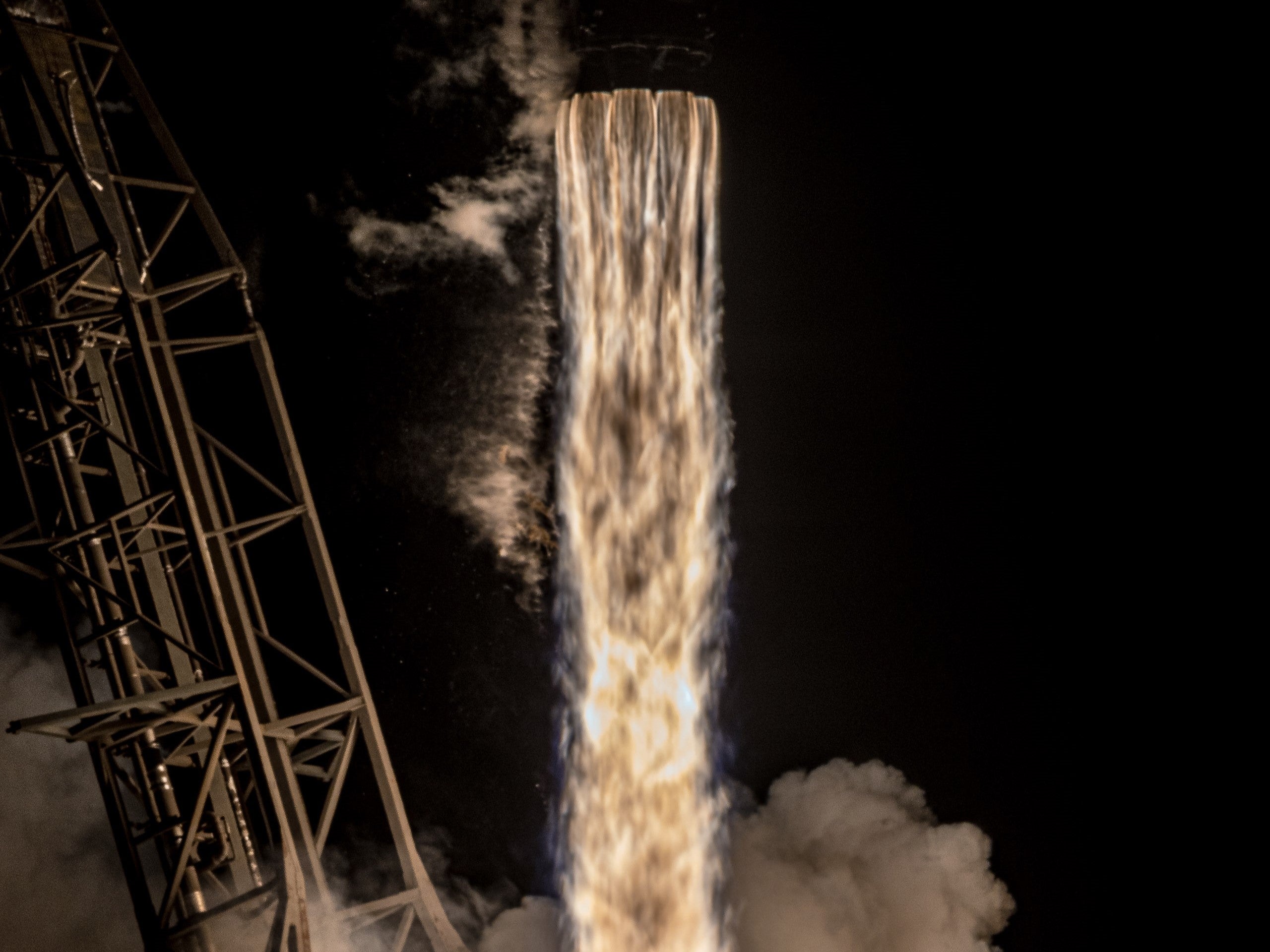 A SpaceX Falcon 9 rocket launching at night