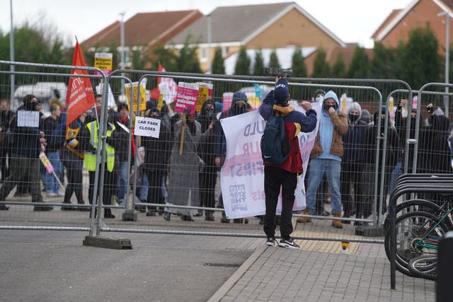 <p>Protesters outside a Holiday Inn, Rotherham</p>
