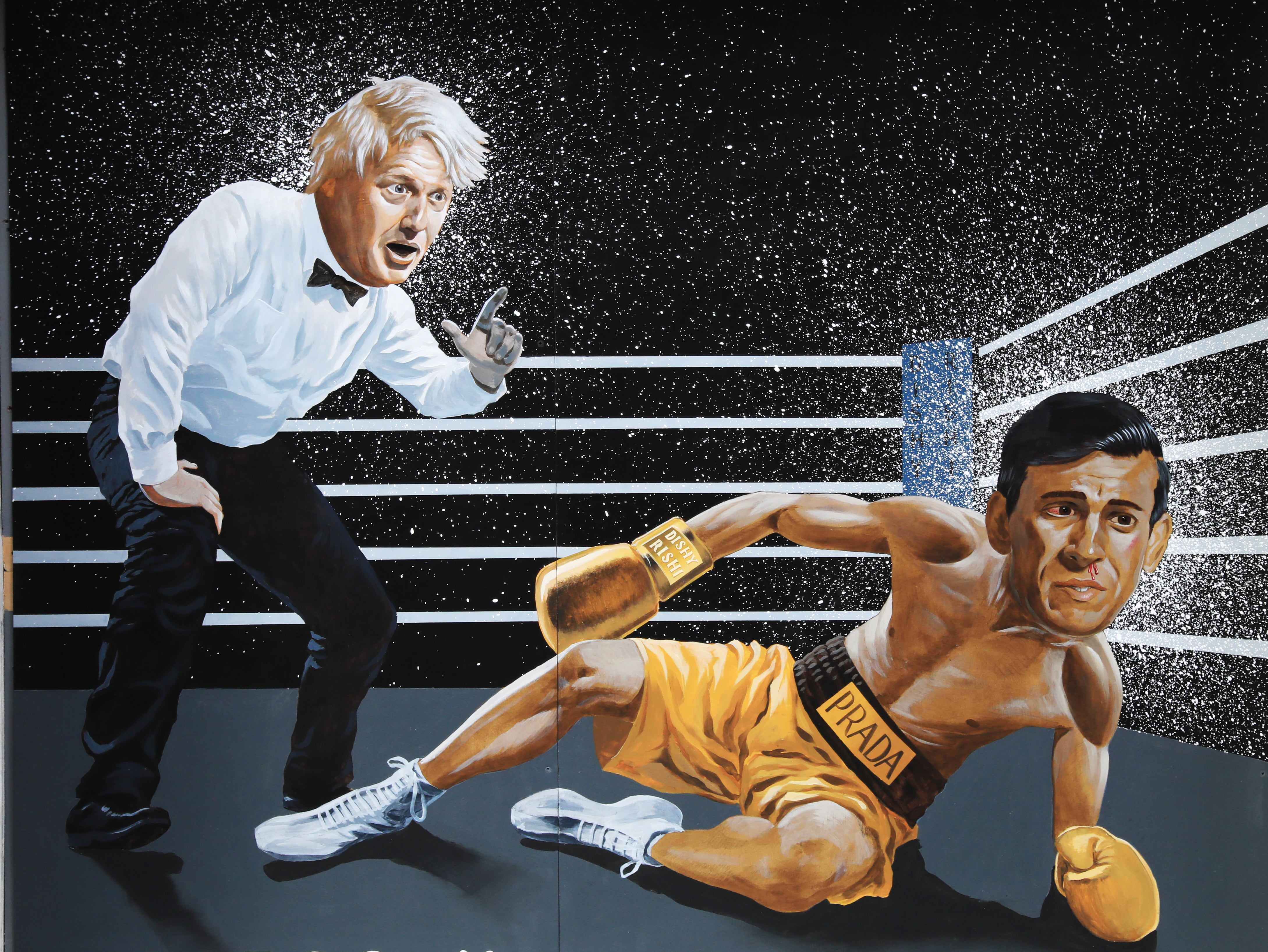 A mural by the artist Ciaran Gallagher depicts Boris Johnson counting out Rishi Sunak