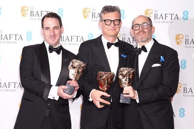From left, James Friend, Malte Grunert and Edward Berger wotj their Baftas for All Quiet on the Western Front (Ian West/PA)